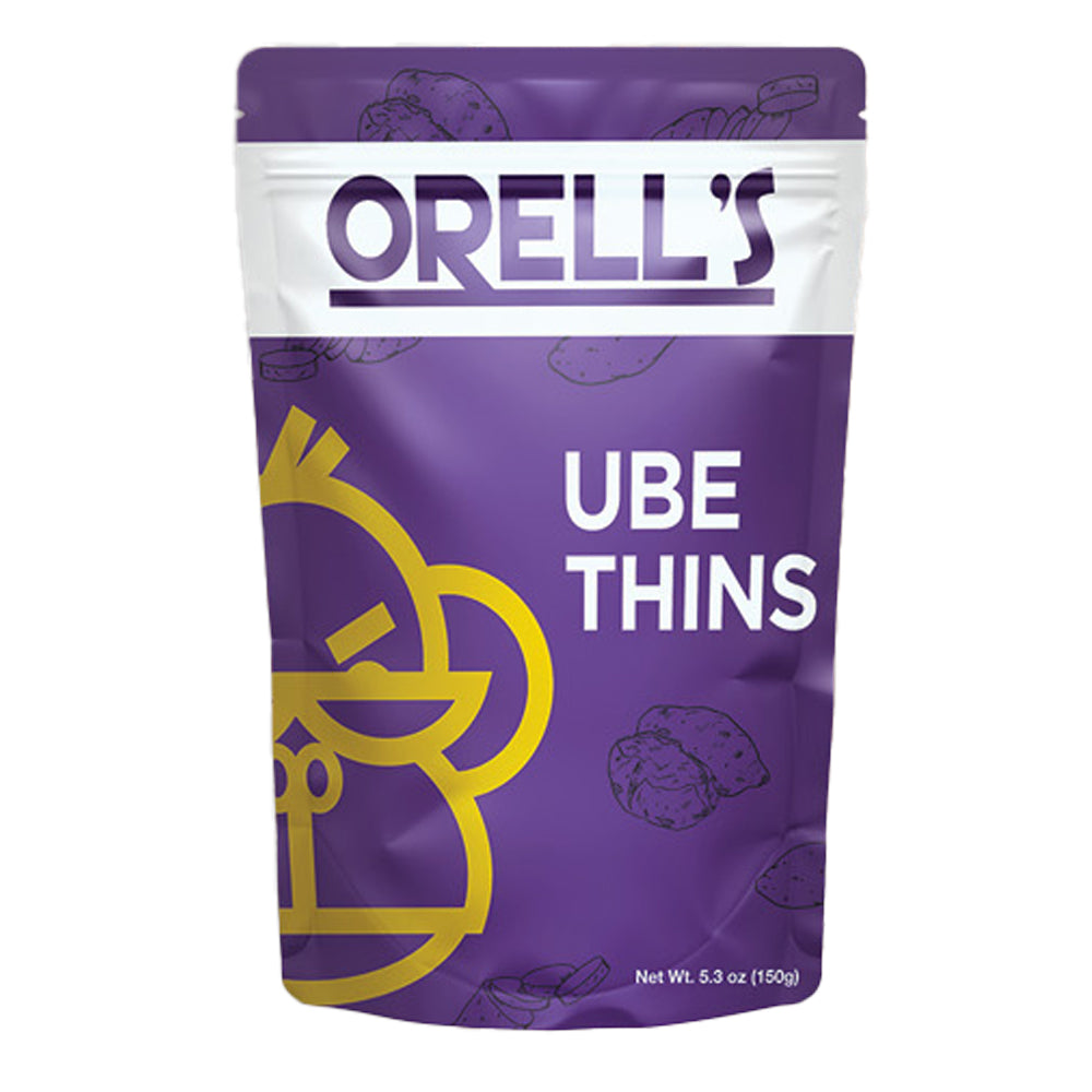 A pouch of Orell's Ube Thins, with the product clearly visible through the packaging. The main color is purple, with an illustration of a cartoon monkey and ube (purple) fruits, indicating the flavor and origin of the snack.