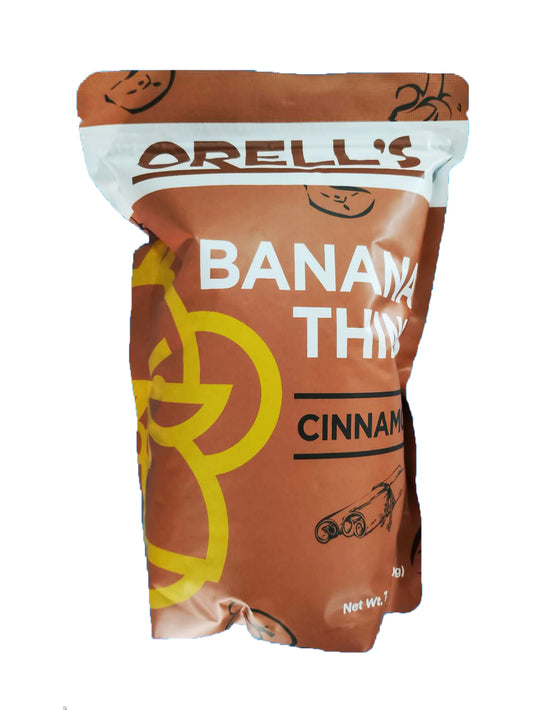 A pouch of Orell's Banana Thin chips with cinnamon flavor. The packaging is brown with yellow and black text, and an image of bananas and cinnamon sticks.